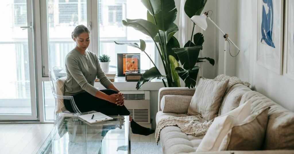 woman sitting in her living room with indoor plants