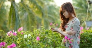 Girl Enjoying Around Flowering Garden
